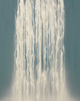 Close-up of a waterfall with water droplets against a dark background