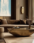 Luxurious living room with brown sofa, gold coffee table, and decorative pillows.