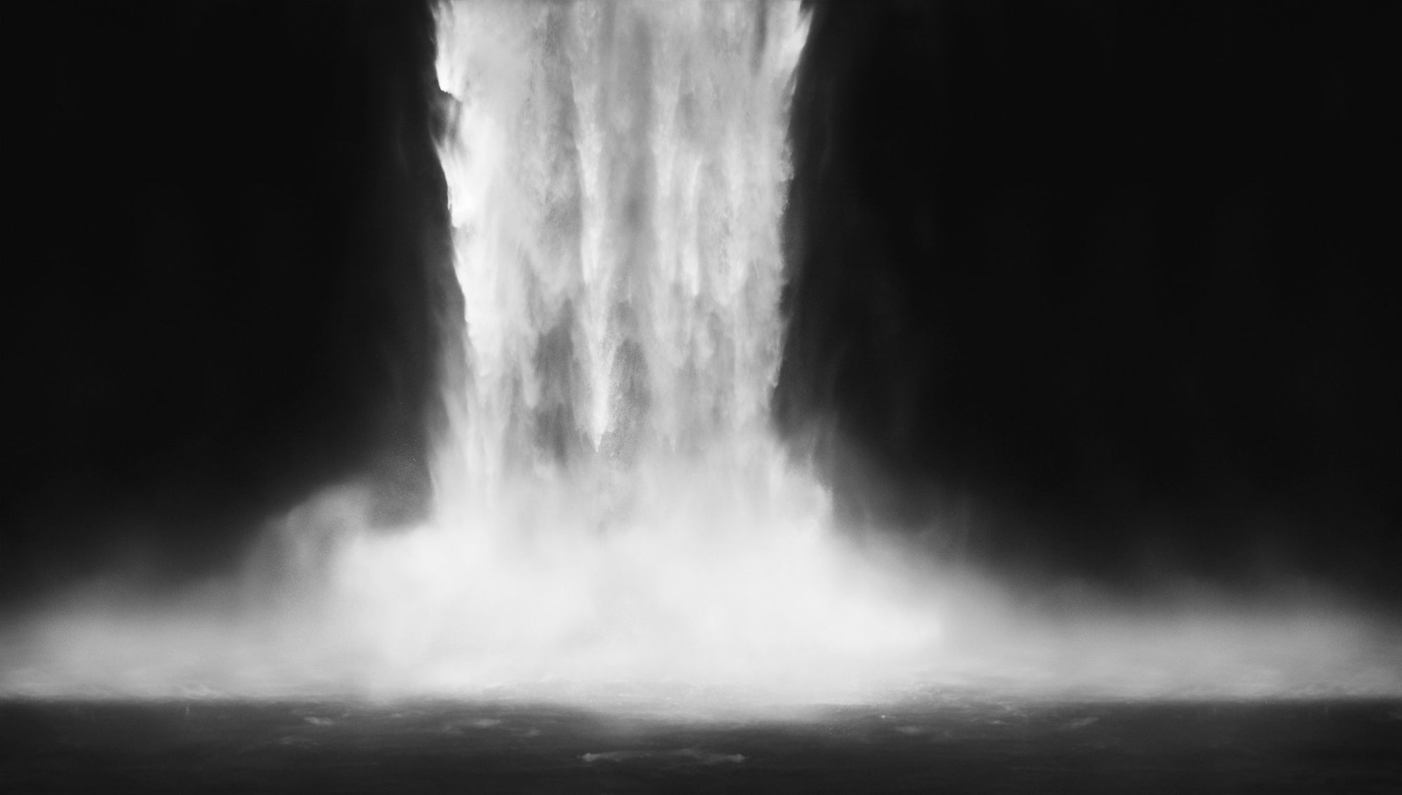 Black and white image of a waterfall with mist