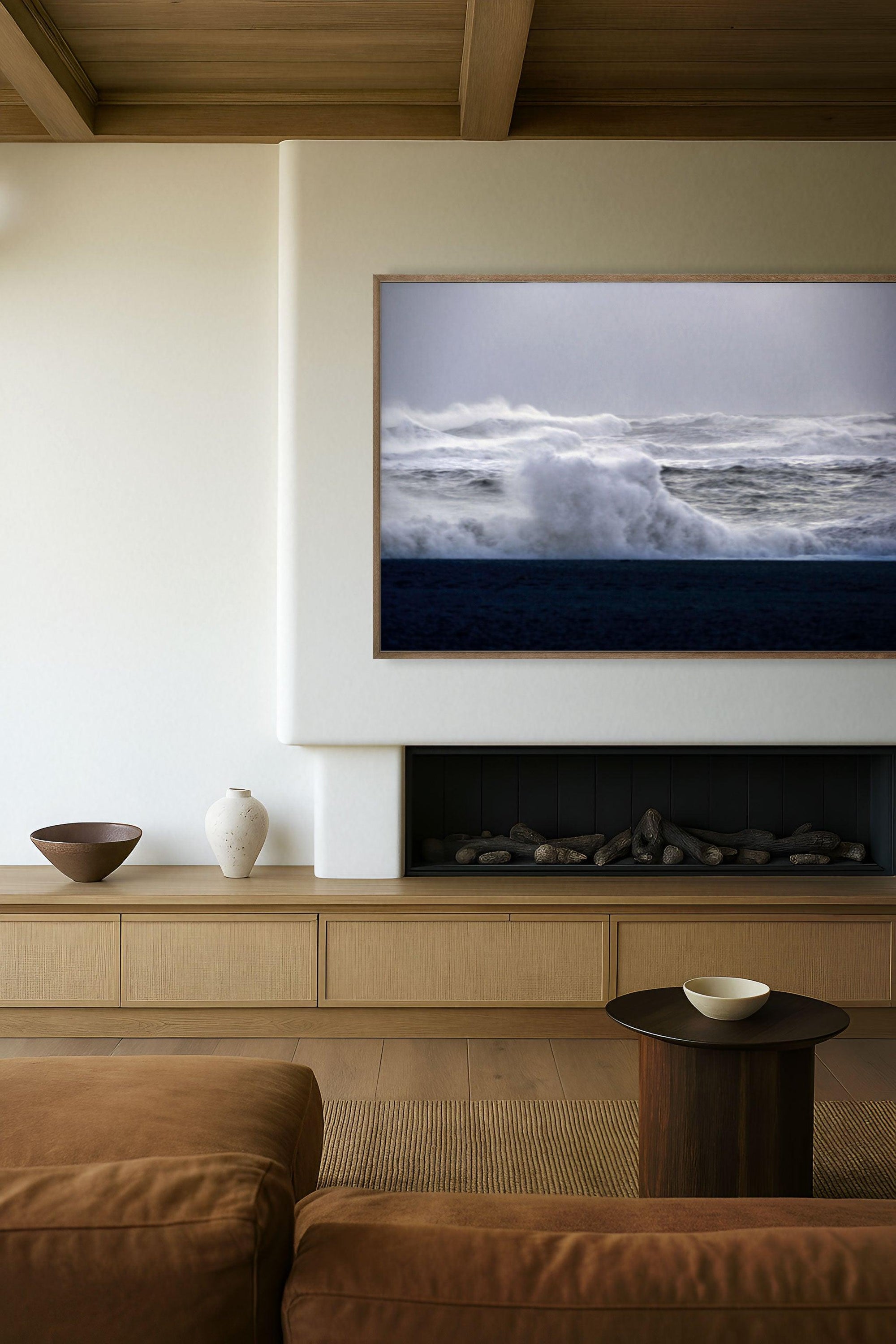 This image features a serene and stylish living room setting, accentuated by the art piece titled "Black Beach Lines". The artwork displays a powerful ocean wave, Its bold, monochrome design contrasting the dynamic texture of the sea with the stark, clean lines of the wave.