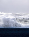A photograph of a stormy sea with dark waves creating a sense of tension and power.
