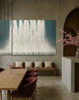Modern interior with abstract artwork, wooden table, and chairs.
