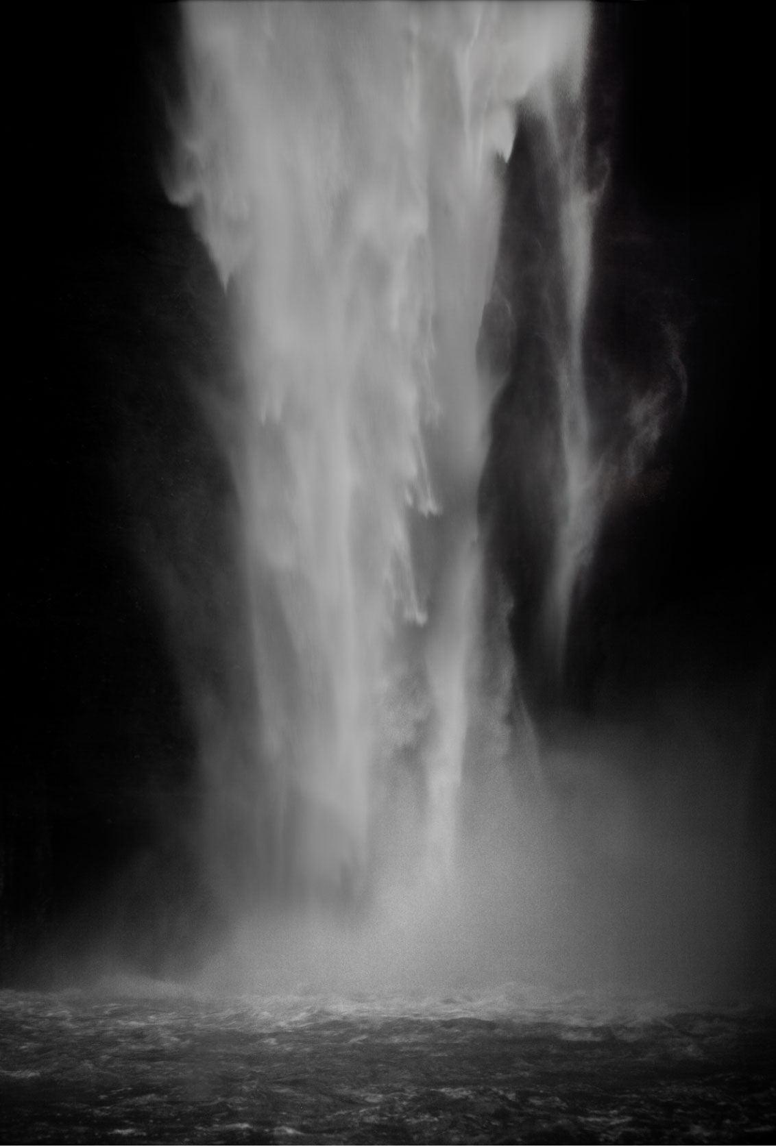 A waterfall painted on a black and white photograph.