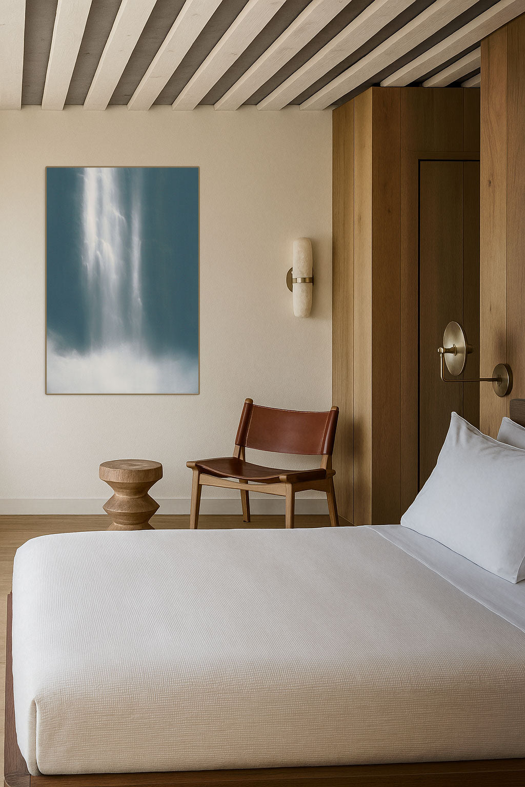 Bedroom with a bed, chair, and wall art on a striped ceiling.