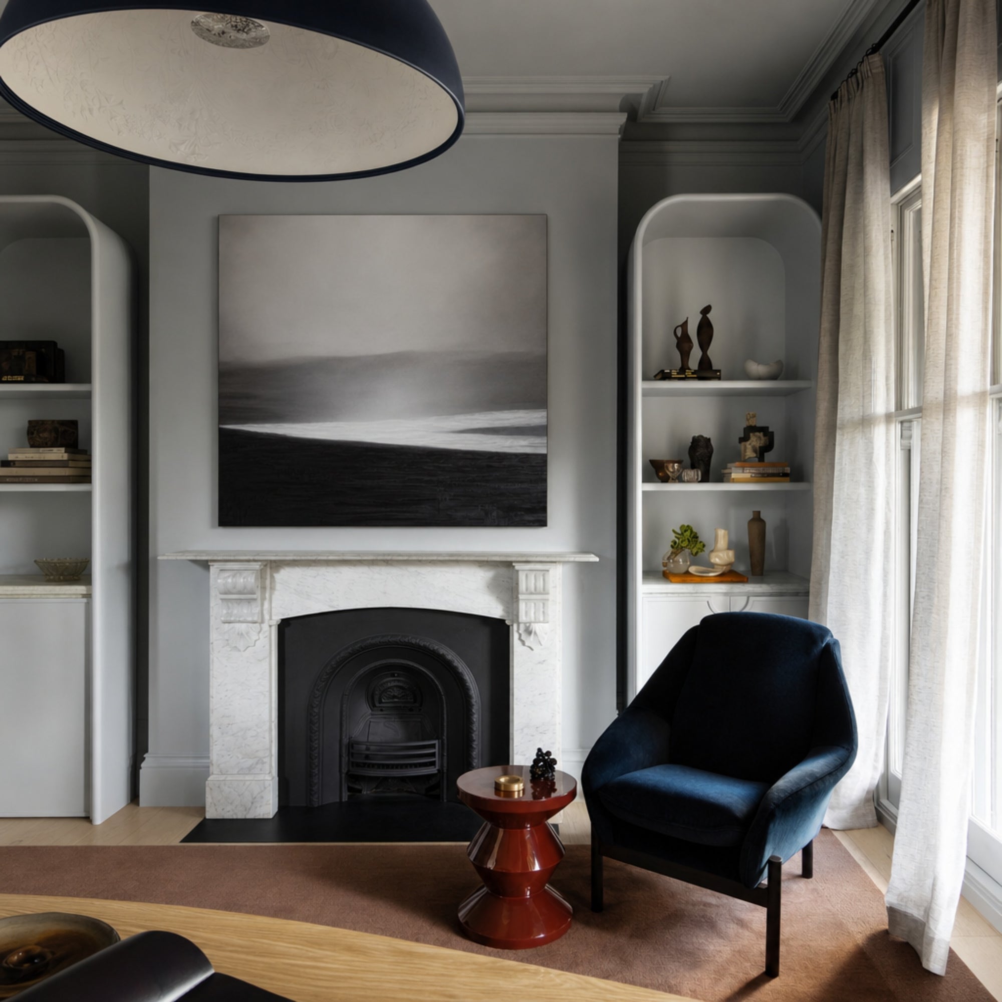 Custom Convergent Lines In A Modern living room with a fireplace, blue armchair, and shelves.